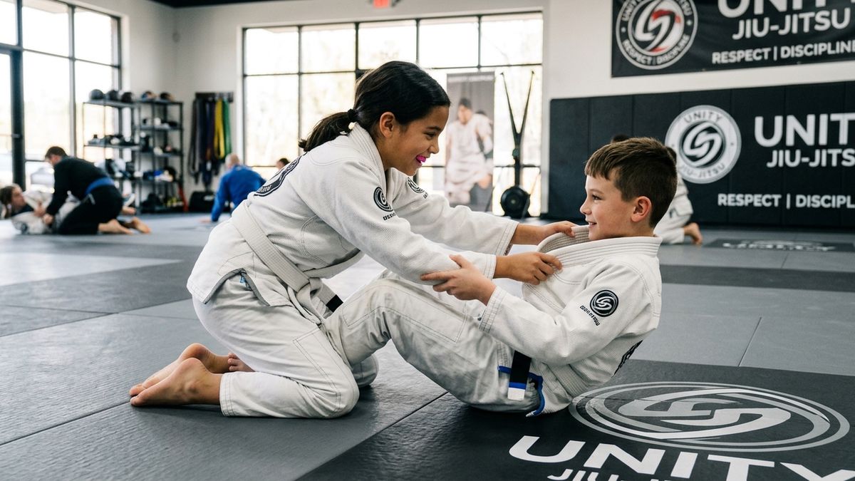 Two kids in BJJ gis practicing a partner drill, showing cooperation and mutual respect on the mat