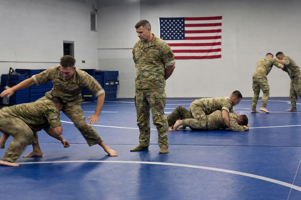 US Army combatives class drilling grappling on training mats