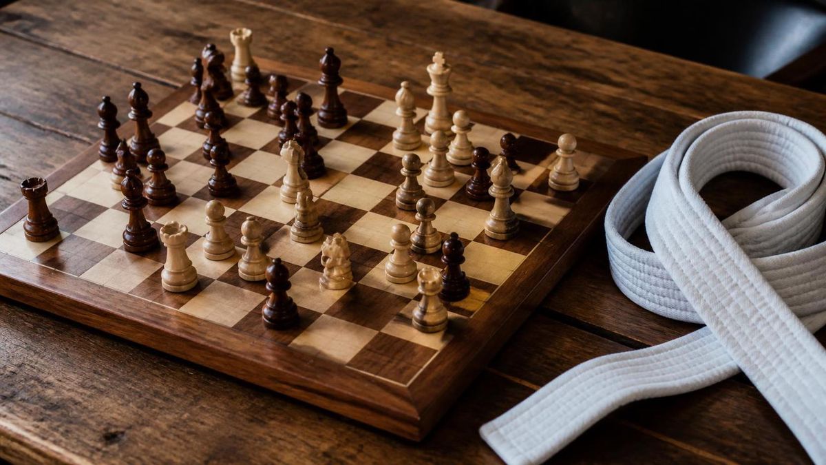 Photoreal chess board mid-game with a white BJJ belt coiled beside it, suggesting puzzle-solving rather than fighting