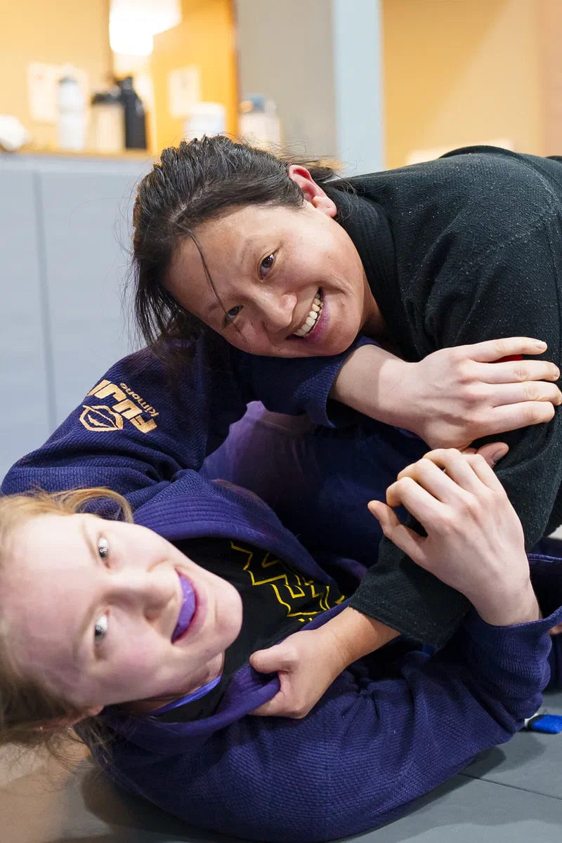 Women learning practical BJJ techniques for self-defense in Madison
