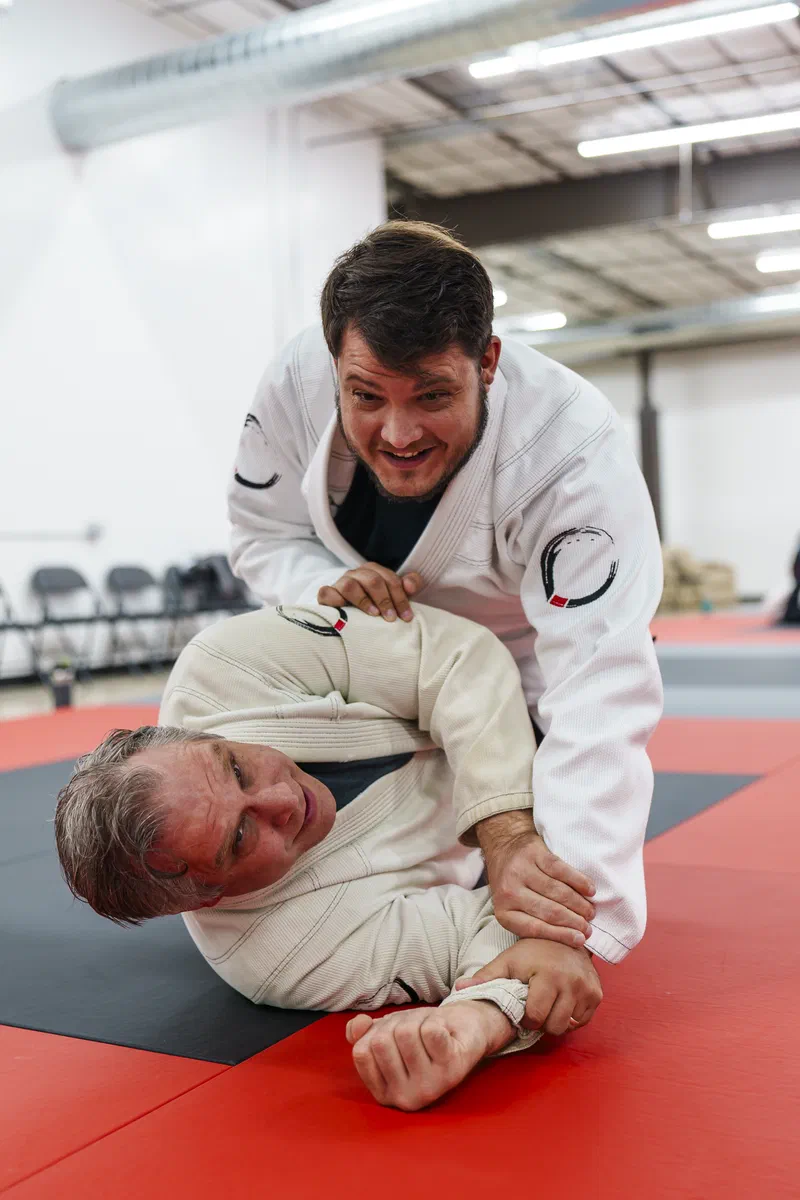 Adult students practicing Brazilian Jiu-Jitsu in gi at Journey Academy