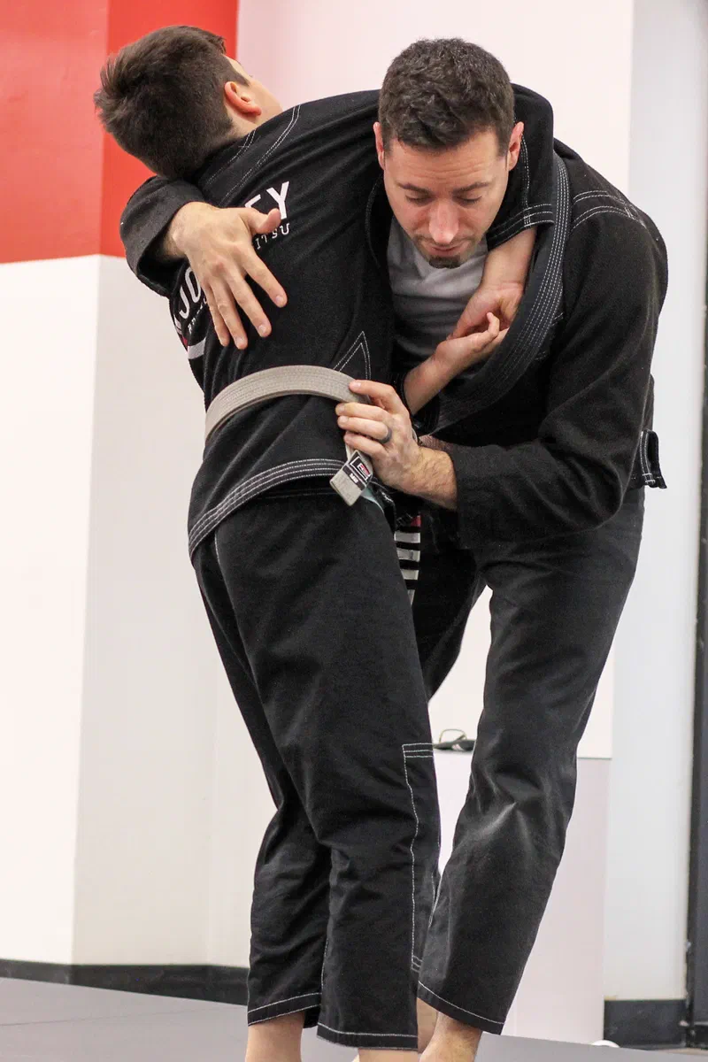 Child learning practical choke defense techniques in Madison self-defense class
