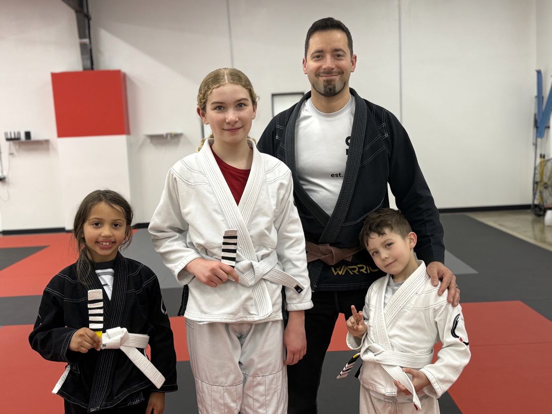 Coach Standing with Promoted Kids