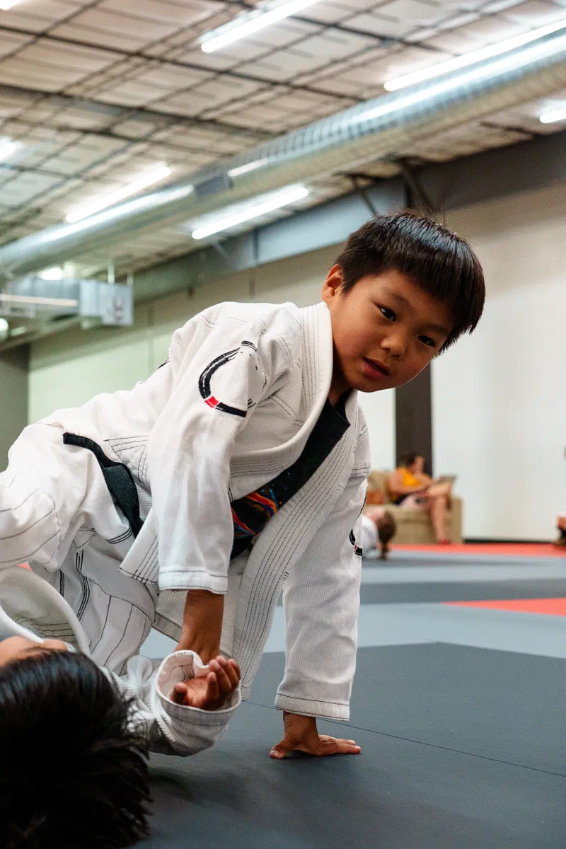 kids having fun rolling in jiu jitsu class in Madison WI