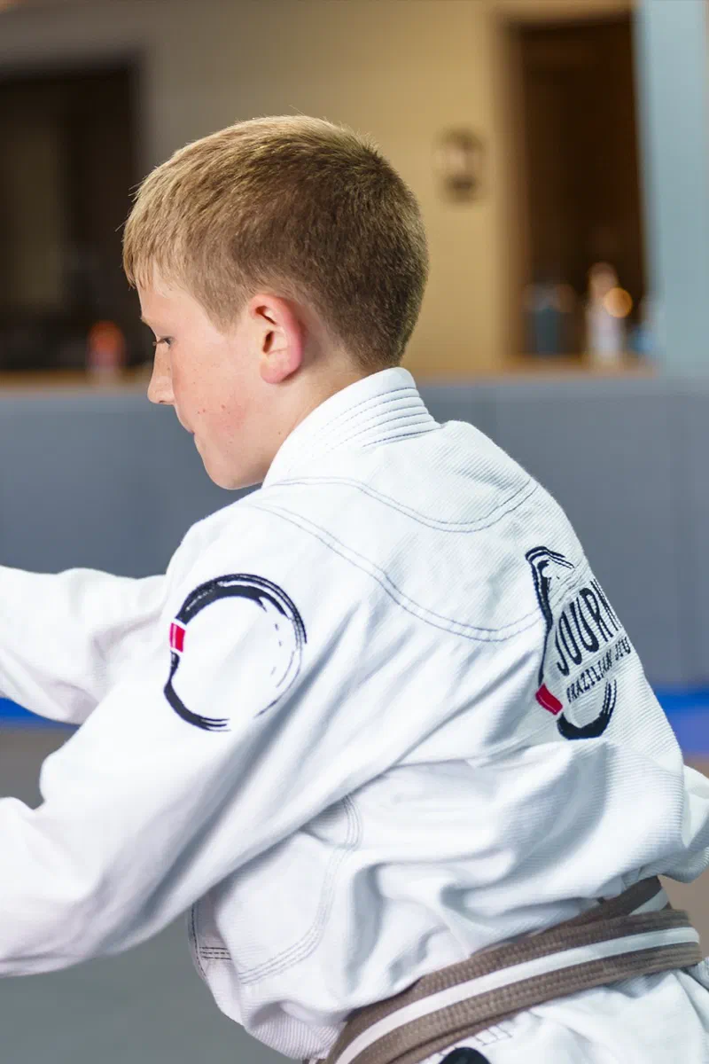 Children practicing Brazilian Jiu-Jitsu together in gi at Journey Academy
