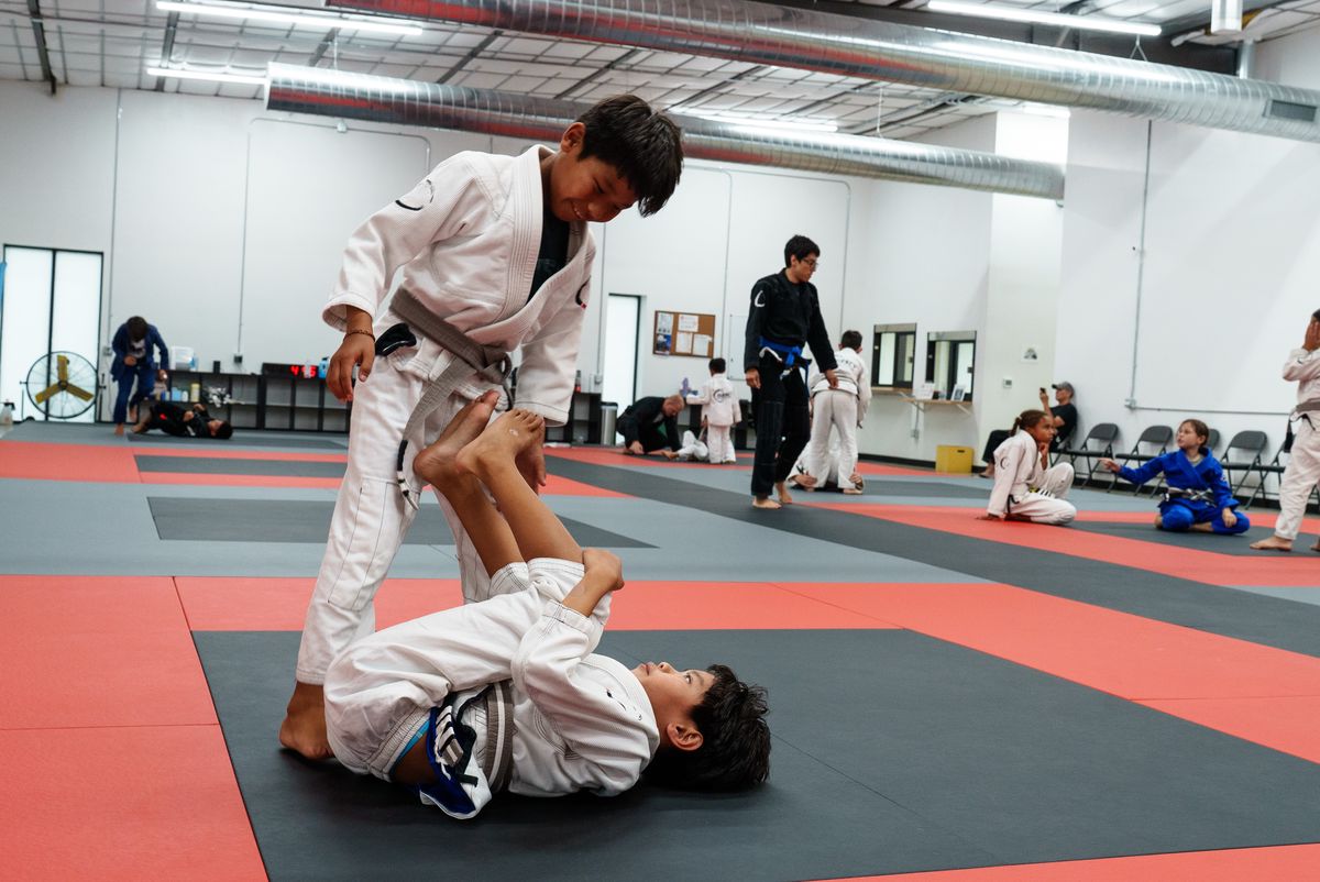 two boys in white gi guard passing drill