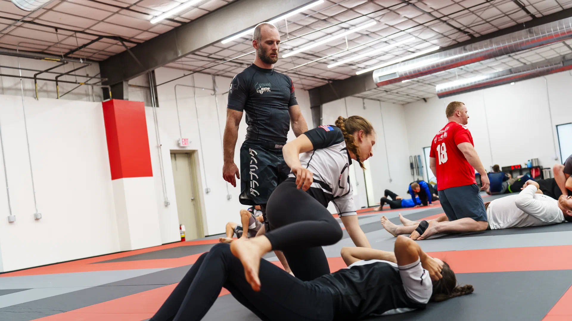 Female students practicing Brazilian Jiu-Jitsu in no-gi attire
