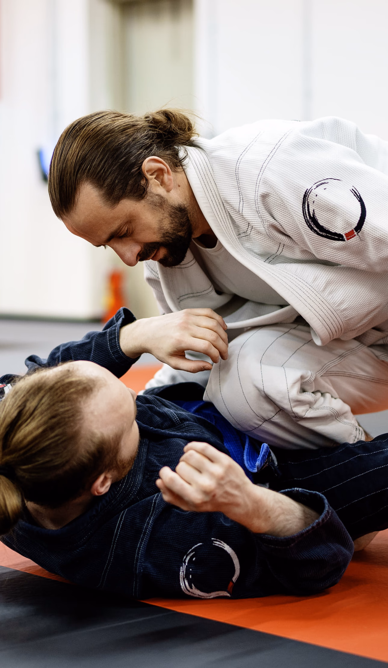 Adult Brazilian Jiu-Jitsu students practicing technique at Journey BJJ Academy in Madison WI