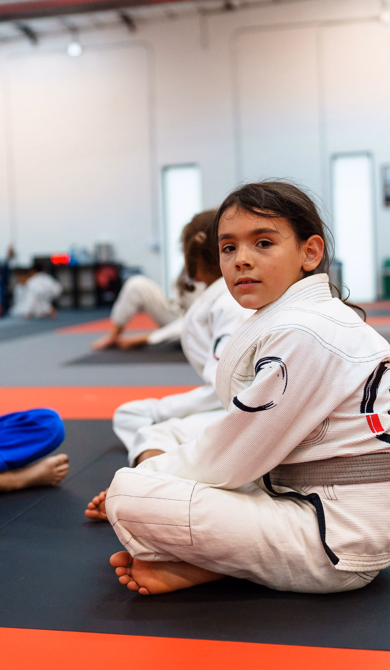 Kids Brazilian Jiu-Jitsu students sitting attentively in class at Journey Academy
