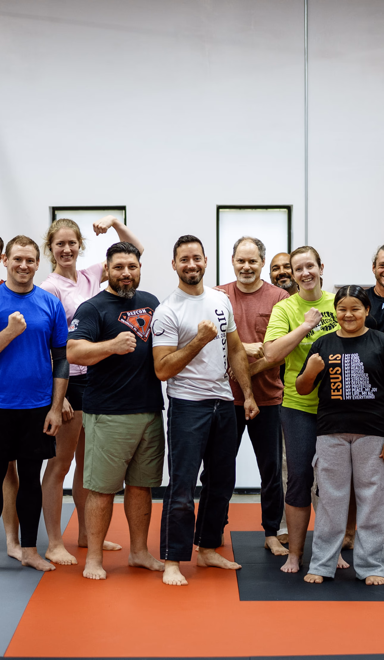 Adult self-defense students smiling together after training at Journey BJJ in Madison WI