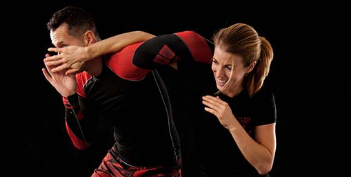 Image of beginner getting pointers from instructor during mma madison classes